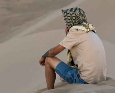 man on sand dune